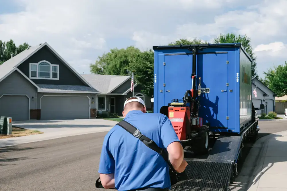 BlueBox delivery truck placing a portable storage container